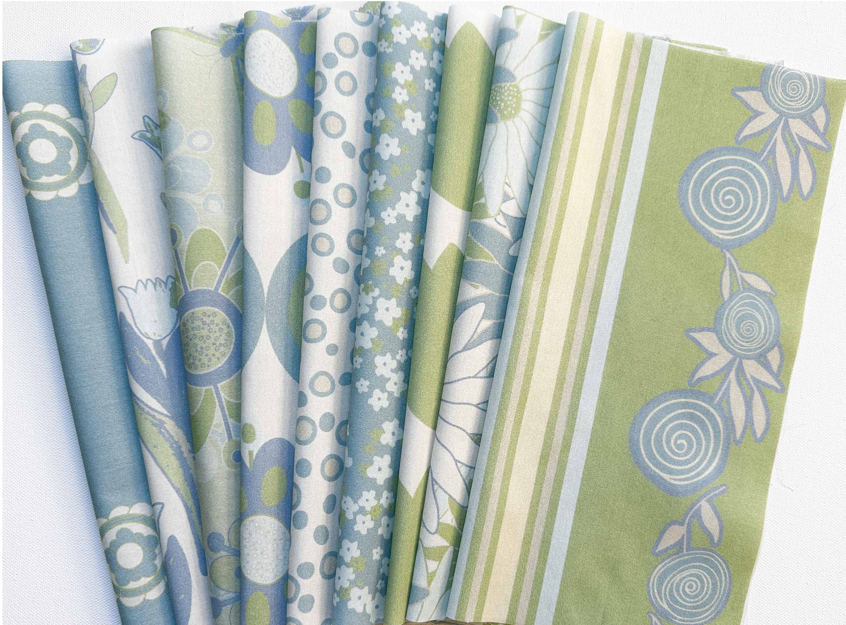 Patterns from the Buds, Blossoms, Wings collection in large scale. The colors are light blue and mint and cream.