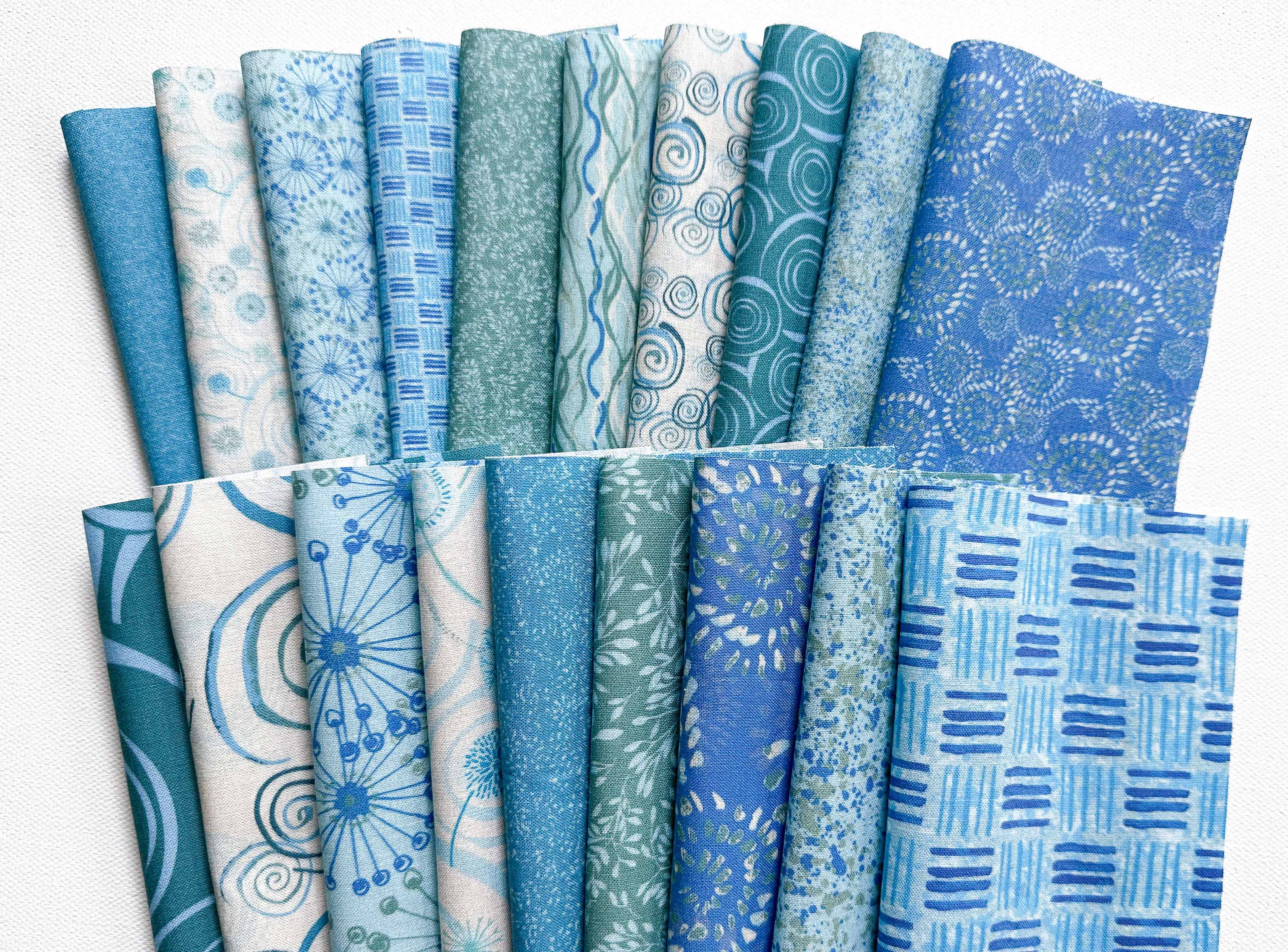 Varied scales of the patterns in Lakeside Connections collection in blue and teal